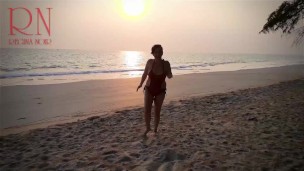 Nice lady at lonely nudist beach. Red swimsuit. Red bikini. Coconut
